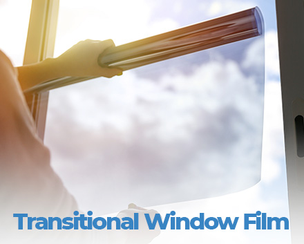 Person Applying Transitional Window Film to Window Which Transitions Light to Dark When Exposed to the Sun